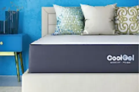 A CoolGel memory foam mattress on a bed with decorative pillows. Is memory foam safe? Yes, this mattress offers safe, comfortable sleep.