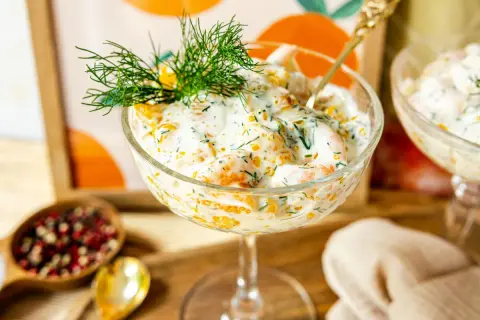 Erfrischender Krabbencocktail mit süßen Mandarinenstücken, cremiger Sauce und Dill garniert.
