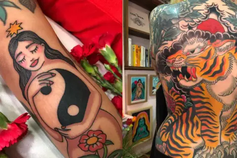 Tatuaje de una mujer con símbolo yin-yang y un tigre rugiendo en la espalda, estilo Diana Deets.