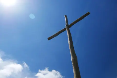 Drewniany krzyż na tle błękitnego nieba. Symbol wiary, który może pomóc zrozumieć, czym się różni prawosławie od katolicyzmu.