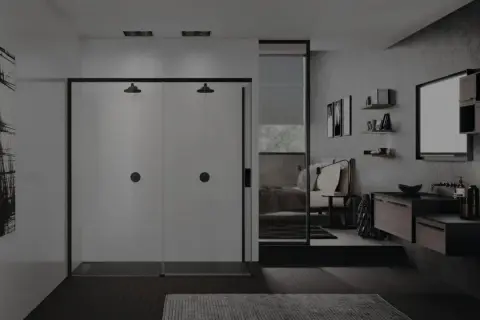 Un elegante bagno in camera con doccia doppia, lavabo sospeso e letto visibile attraverso uno specchio.
