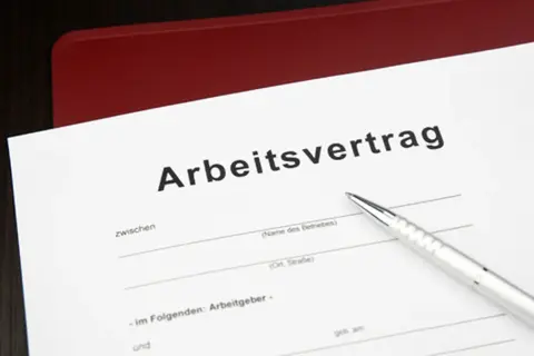Arbeitsvertrag mit befristung mit sachgrund. Ein Stift liegt bereit, um die Details des Vertrags zu unterzeichnen.