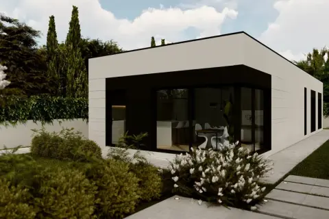 Casa moderna de construccion modular con amplios ventanales y jardín exuberante.