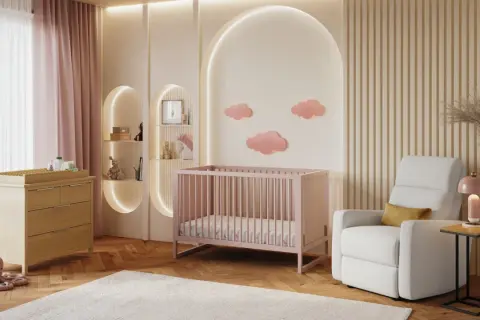 A serene nursery with pink crib, changing table, and cloud decor. This sweet setup is perfect for baby girl nursery themes.