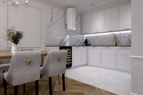 Elegancka kuchnia z białymi frontami, okap tuba nad blatem z marmurowym wzorem. Aranżacje stołu z krzesłami tworzą przytulną jadalnię.