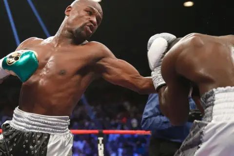 Boxer throws a punch, showcasing the intensity of most popular boxing weight classes.