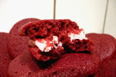 En närbild på en delad red velvet kaka med krämig fyllning.