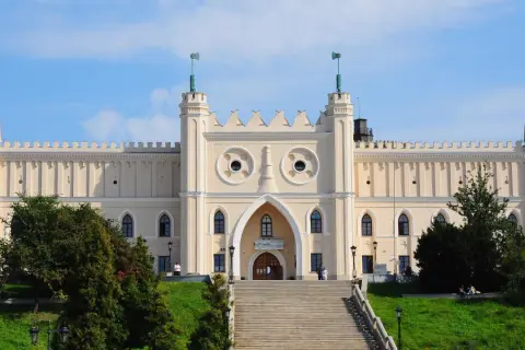 Zamek Lubelski zaprasza na bezpłatne zwiedzanie. Monumentalna budowla z charakterystycznymi wieżyczkami i dwoma okrągłymi oknami na fasadzie.