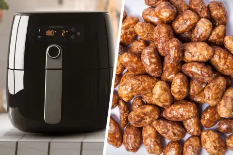 Schwarzer Airfryer neben einem Haufen glänzender, karamellisierter gebrannter Mandeln. Perfekt für süße Snacks!