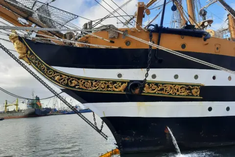 La prua ornata del veliero Amerigo Vespucci ad Ancona, con catene e decorazioni dorate.