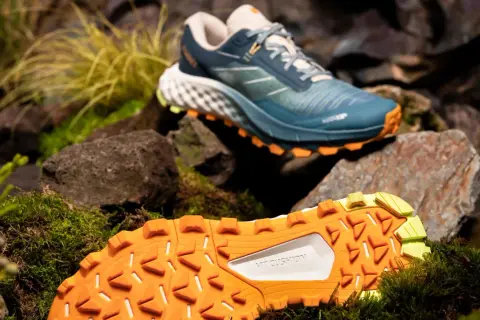Buty trailowe co to? Zobacz te niebieskie buty z pomarańczową podeszwą, idealne na górskie wędrówki.