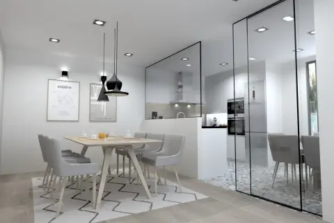 Comedor moderno con **cocina semiabierta cristal**. Mesa de madera con sillas grises, alfombra geométrica y cocina visible tras panel de cristal.
