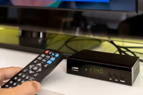 Pilot steruje dekoderem do telewizji naziemnej, który wyświetla godzinę.