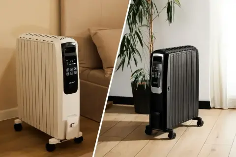 Biały i czarny grzejnik olejowy na kółkach. Czy grzejnik olejowy może się zapalić? Bezpieczne ogrzewanie domu.