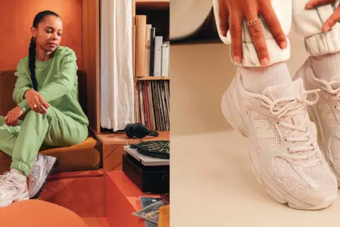 Donna con tuta verde e sneakers New Balance 530, un look casual e alla moda.