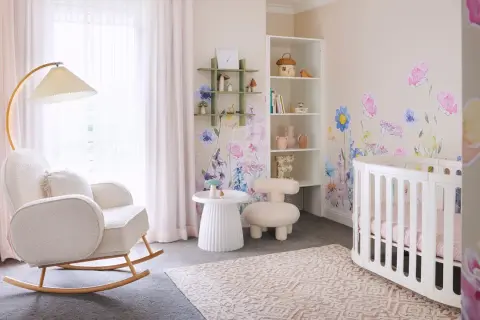 Dreamy white nursery ideas with floral wall decals, a cozy rocking chair, and a sweet crib.