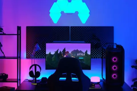 A gamer's setup with RGB lighting, where RGB stands for Red, Green, and Blue, creating a vibrant atmosphere.