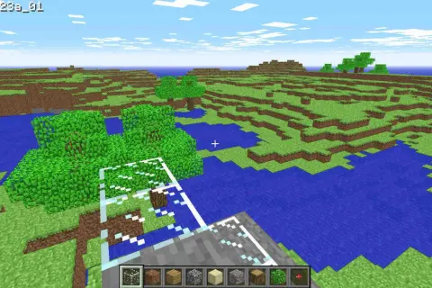 Wczesna wersja Minecrafta z blokami trawy, wody i drzew.