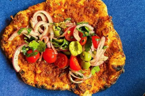 Lahmacun med färsk topping av tomat, lök och oliver. Ett enkelt lahmacun recept att prova.