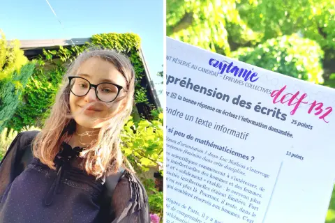 Uśmiechnięta dziewczyna w okularach na tle zieleni, trzyma w ręku test z języka francuskiego, poziom delf B2.