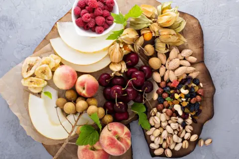Ett uppdukat fat med frukt, bär och nötter – perfekt för ett nyttigt fika på jobbet. Här finns hallon, physalis, körsbär, nektariner, melon, bananchips, longan och en blandning av nötter och torkad frukt.