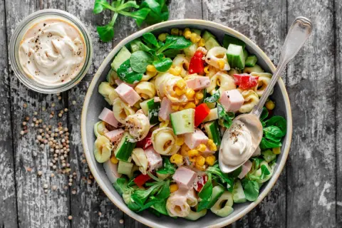 Najlepsza sałatka z tortellini: pyszne połączenie makaronu, szynki, kukurydzy, ogórka i papryki, polane kremowym sosem. Idealna na każdą okazję!