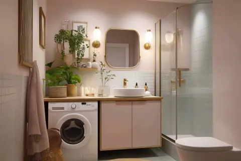 Ein helles Badezimmer mit Waschmaschine, Waschbecken, Spiegel und Dusche. Pflanzen und Dekoration sorgen für Ordnung im Badezimmer.