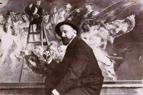 Malczewski obrazy: artysta w kapeluszu przed malowidłem z drabiną i postaciami.