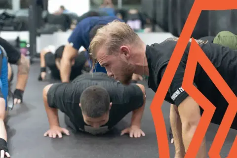 Boxers perform push-ups as part of their intense boxing stretches routine, building strength and endurance for the ring.