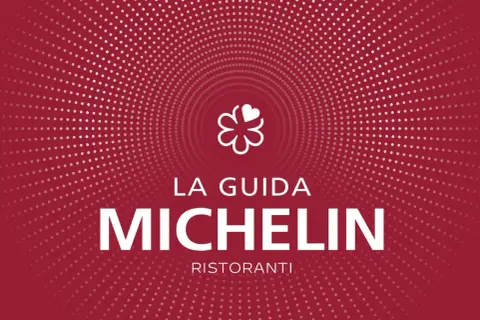 Logo La Guida Michelin con la scritta "MICHELIN RISTORANTI". Un simbolo di eccellenza per i ristoranti 3 stelle Michelin Italia.
