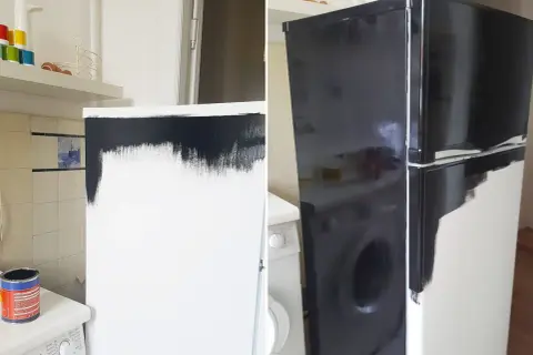 En burk med svart färg står bredvid en tvättmaskin. Kylskåpet är halvmålat i svart, en del av arbetet med att måla kylskåp.
