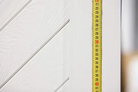 Miarka pokazuje 30 cm. Sprawdzamy, jaki otwór pod drzwi 80 cm będzie odpowiedni.
