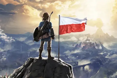 Link z tarczą i łukiem na szczycie góry, obok polska flaga. Widok na górzysty krajobraz z zamkiem w oddali. Zelda po polsku.