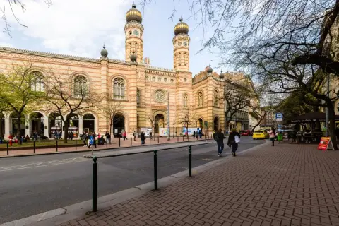Stora synagogan i Budapest, ett landmärke i de judiska kvarteren, med folk som promenerar på trottoaren.