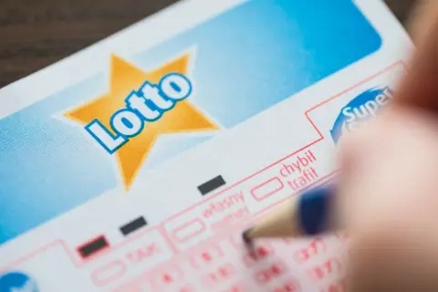 Ktoś wypełnia kupon Lotto. Czy rozwód a wygrana w loterii to miliony wchodzące w skład majątku wspólnego?