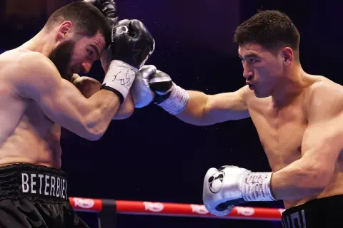 Two boxers clash in the ring. The boxer on the left, with "BET..." on his shorts, is in the light heavyweight beterbiev weight class.