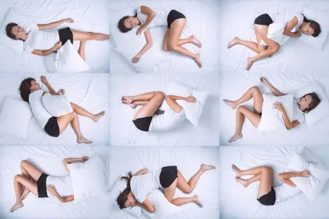 A woman in various positions on a white bed, illustrating tossing and turning at night. She clutches a pillow, seeking comfort.