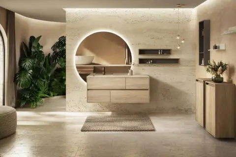 Une salle de bain moderne avec des plantes luxuriantes, un meuble-lavabo suspendu en bois clair et un grand miroir rond éclairé. Une véritable inspiration salle de bain.