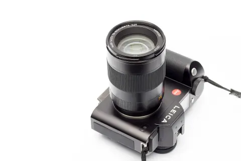A black Leica camera with a Leica 75mm Summicron lens attached, ready to capture stunning portraits.