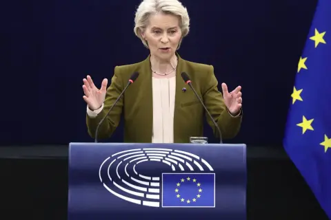 Ursula von der Leyen przemawia przy mównicy z logo Parlamentu Europejskiego i flagą UE.