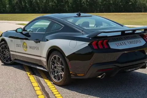 Czarny Ford Mustang w barwach policji "State Trooper" z napisem na boku i tyle.