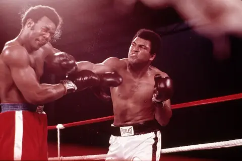 Two boxers in the ring, one landing a punch. The intensity of the fight suggests a close match, perhaps even a unanimous drawing.