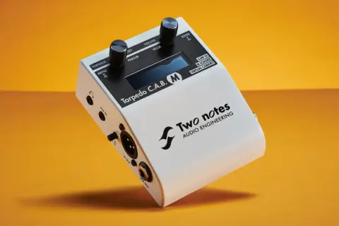 Two Notes Torpedo C.A.B. M, a white audio device with knobs and ports, offering free IR cabs for virtual cabinets.