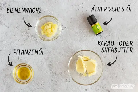 Zutaten für selbstgemachte Lotion: Bienenwachs, Pflanzenöl, Kakaobutter und ätherisches Öl.