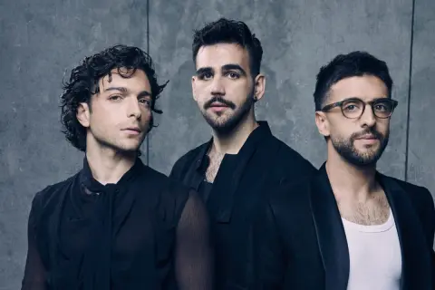 Tre uomini in abiti scuri, pronti per il volo.