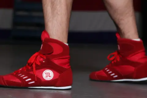 Red boxing shoes ready for intense boxing footwork drills.