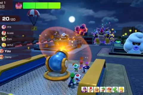 Postacie z Mario Party Jamboree w nocy, Bowser i Boo patrzą na armatę.