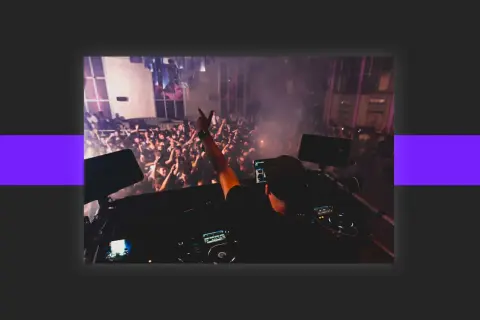 DJ playing to a cheering crowd, a scene that inspires anyone wondering how to get DJ gigs.
