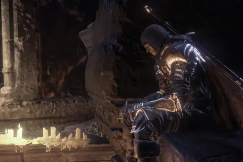 Rycerz w zbroi siedzi przy świecach, szukając wskazówek w **Dark Souls 3 poradnik**.