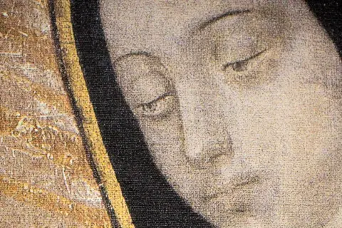 Matka Boska z Guadalupe, jej oczy pełne łagodności patrzą z obrazu. Złote zdobienia i ciemny welon podkreślają jej majestat.